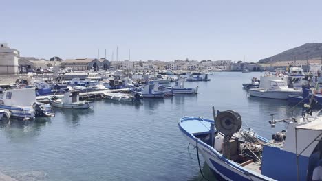 Panoramic-view-of-boats-in-the-blue-sea-port-of-Favignana-Island-Italy,-region-of-Sicily