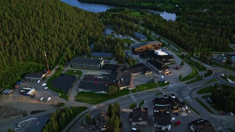 Drone-overlooking-shops-and-hotels-in-the-Levi-town,-summer-evening-in-Finland