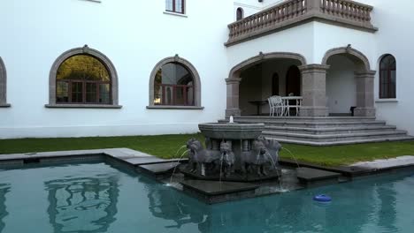 Mexico-city-reforma-lomas-house,-drone-shot,-fountain-backgraound