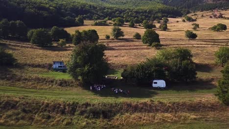 A-drone-flying-backwards-with-its-camera-focused-on-people-in-the-beautiful-natural-Park-of-Torocko---Romania