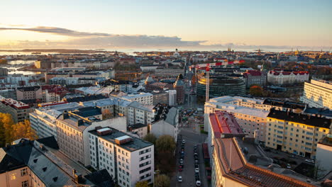 Timelapse:-Traffic-and-a-crane-on-a-street,-fall-sunset-in-Kallio,-Helsinki