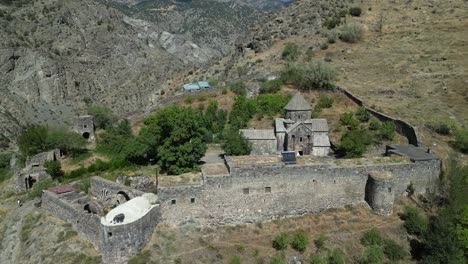 Ancient-Gndevank-Monastery-overlooks-rugged-Armenian-gorge,-aerial