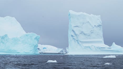 Antártida-Dramático-Paisaje-De-Iceberg-Con-Formas-Sorprendentes-De-Grandes-Icebergs-Azules,-Enormes-Y-Extraños-Icebergs-Hermosos-En-Agua-De-Mar-En-El-Frío-Paisaje-Marino-Invernal-En-La-Península-Antártica