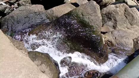 River-water-splashes-under-the-flow-of-Tammasapi-Waterfall-in-Mamuju,-West-Sulawesi,-Indonesia