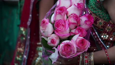 Indian-American-woman-holding-a-bouquet-of-roses