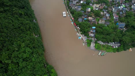 Aerial-birdseye-dolly-left-of-Li-Jiang-River-with-brown-and-contaminated-waters,-China