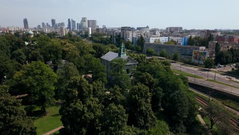 Aerial-View-of-Western-Suburbs-of-Warsaw,-Poland,-Catholic-and-Orthodox-Church,-Street-Traffic,-Buildings-and-Downtown-in-Skyline