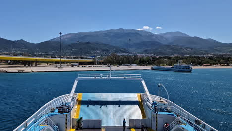 Sail-in-front-of-a-motor-boat-on-Greek-river-rio-bridge-panoramic-at-daylight