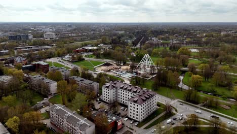Riga,-Latvia,-Europe---A-Ferris-Wheel-Being-Constructed-in-Uzvaras-Park---Aerial-Drone-Shot