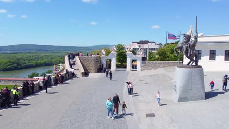 Tourists-and-Statue-at-Vienna-Gate-in-Bratislava-in-aerial-dolly-in-view