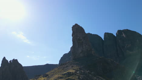 Low-Angle-Aerial-around-Old-Man-of-Storr-Pinnacle,-Isle-of-Skye,-Sunny