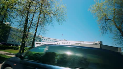 Footage-of-the-Daugavpils-University-building-adorned-with-Latvian-flags-during-a-spring-travel-trip