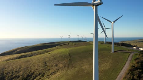 Renewable-energy-wind-farm-aerial-at-sunset,-South-Australia