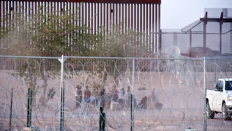 Waiting-Ground:-Family-Seeks-Refuge-at-US-Border-Barrier