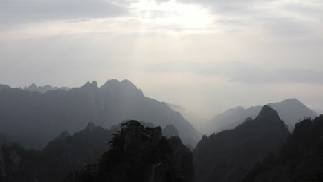 Amazing-aerial-footage,-pull-back-over-China-Yellow-Mountain-valley-peaks