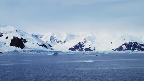 Winter-Mountains-Scenery-in-Snow-and-Ice,-Beautiful-Dramatic-Blue-Landscape-in-Antarctica-on-the-Antarctic-Peninsula,-Cold-Weather-Conditions-with-Big-Mountains