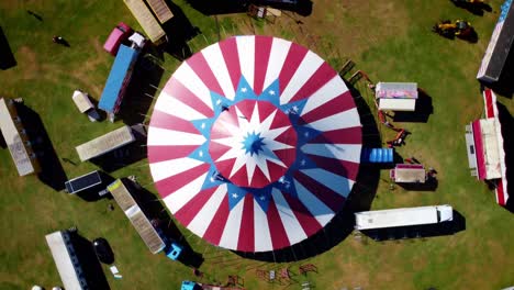 Big-Top-Circus,-Bird's-Eye-spinning-and-rising-Drone-shot