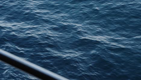 View-to-the-water-from-cruise-ship-balcony-as-waves-splash-by