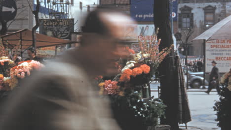 Colorful-Flower-Stalls-and-Shoppers-on-a-Busy-Street-During-Daytime