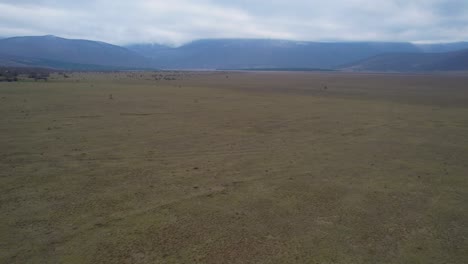 A-beautiful-landscape-drone-video-of-an-empty-countryside-field-in-Croatian-region-of-Lika-in-Croatia,-Europe