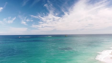 Aerial-view-over-ocean-with-geological-drilling-platform-at-Eden-Beach,-Perth