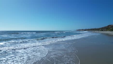 Drone-flight-over-ocean-waves-on-a-beautiful-sunny-day-in-Carlsbad-California