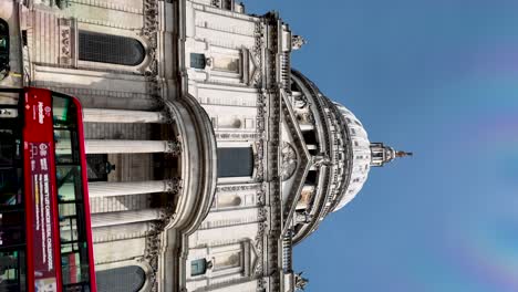 Low-Angle-Looking-Up-At-St-Paul's-Cathedral-With-Sightseeing-Bus-Stuck-In-Traffic-Along-St