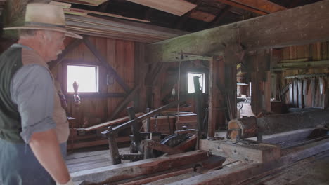 A-typical-19th-century-sawmill-in-action-cutting-a-log-into-planks