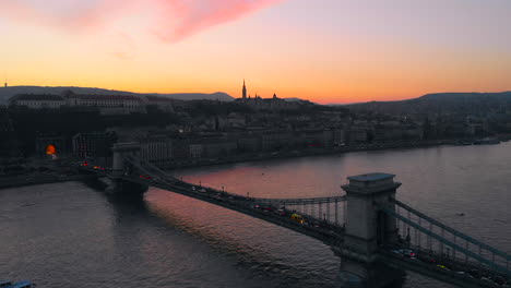 Aerial-shot-in-over-the-Chain-bridge,-as-an-ambulance-stacked-in-the-traffic,-cruise-ship-in-the-left-bottom-corner