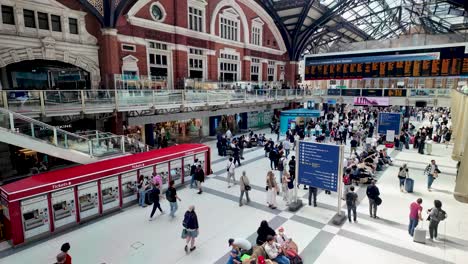 Liverpool-Street-Station,-London,-England,-as-people-leisurely-stroll-through-its-bustling-interior