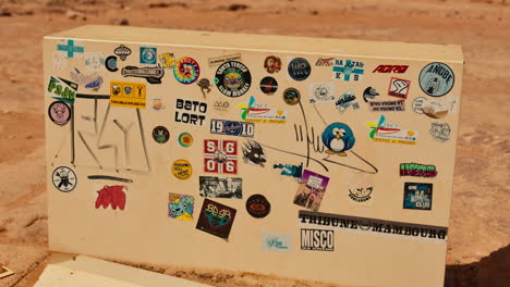 Sticker-Covered-Box-in-Desert-Setting