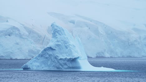 Big-Iceberg-in-Antarctica-Winter-Scenery,-Amazing-Shape-Ice-Formation-of-Massive-Large-Enormous-Blue-Icebergs-in-Antarctic-Peninsula-Landscape-Seascape-with-Ocean-Sea-Water