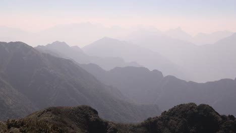 layers-of-mountain-ridges-on-Fansipan,-the-highest-mountain-in-Indochina-located-in-Sapa,-Vietnam