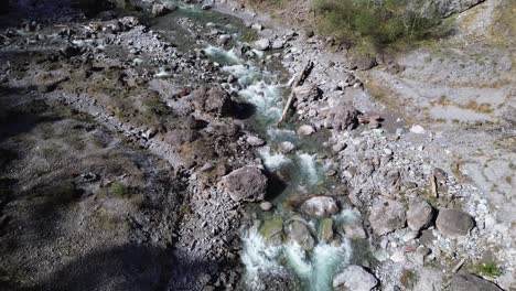 Drone-Orbit-above-River-with-Crystal-Clear-Turquoise-Water-in-Mountain-Valley,-Europe