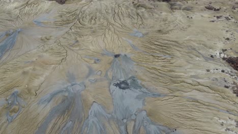 mud-volcanoes-surrounded-by-arid-land-amidst-cracks-and-tectonic-fissures