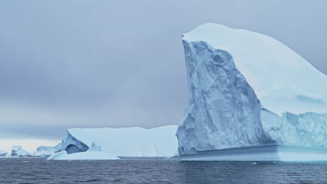 Antarctica-Iceberg-Ice-Formation-Floating-in-Ocean-Close-Up,-Blue-Antarctica-Icebergs-with-Amazing-Shapes-in-Antarctic-Peninsula-Sea-Water-in-Winter-Seascape,-Iceberg-Detail-in-Icy-Seascape-Landscape