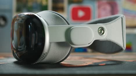 Slider-shot-of-Apple-Vision-Pro-augmented-or-virtual-reality-headset-on-table-indoors