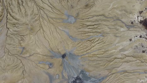 mud-volcanoes-surrounded-by-arid-land-amidst-cracks-and-tectonic-fissures