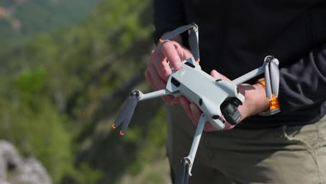 Male-Inserting-And-Taking-Out-Battery-From-Mini-Drone-Holding-In-Hands