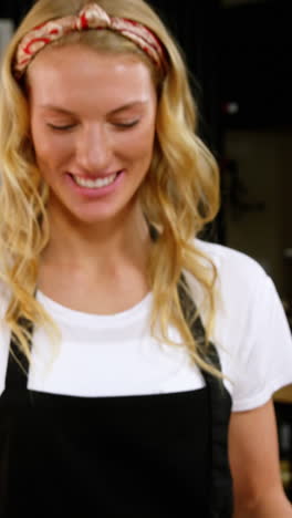 Portrait-of-smiling-waitress-standing-with-dessert