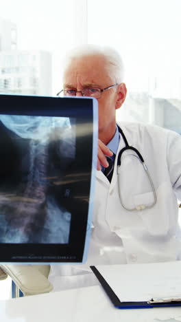 Male-doctor-and-coworker-examining-x-ray