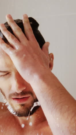 Man-taking-a-shower-in-bathroom