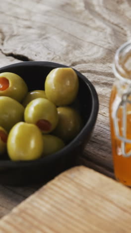 Crispy-biscuits,-knife,-olives,-jam,-rosemary-herb-and-walnuts-