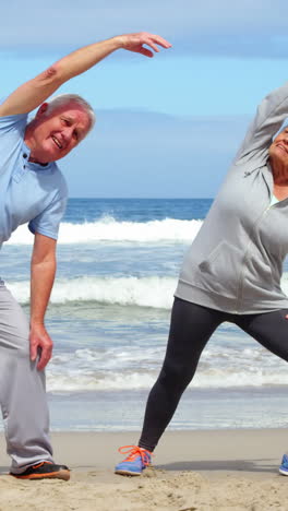 Senior-couple-performing-stretching-exercise