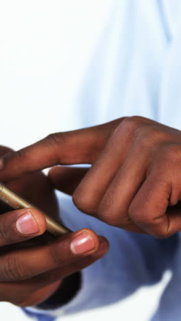 Mid-section-of-businessman-using-mobile-phone