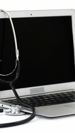 Close-up-of-stethoscope-with-laptop