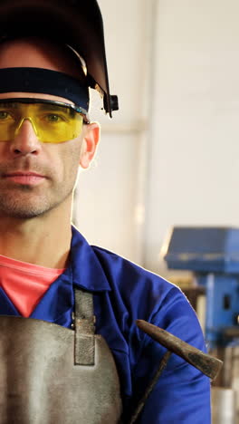 Portrait-of-male-welder-standing-with-arms-crossed