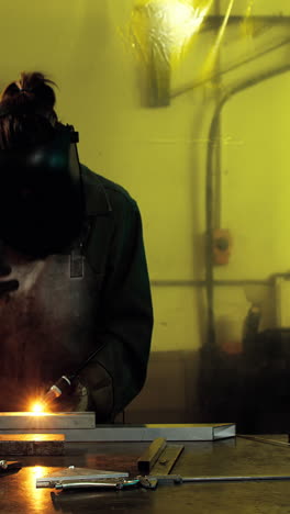 Female-welder-welding-a-metal