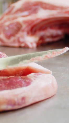 Close-up-of-knife-on-sliced-red-meat