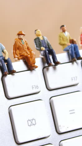 Figurine-sitting-on-a-keyboard